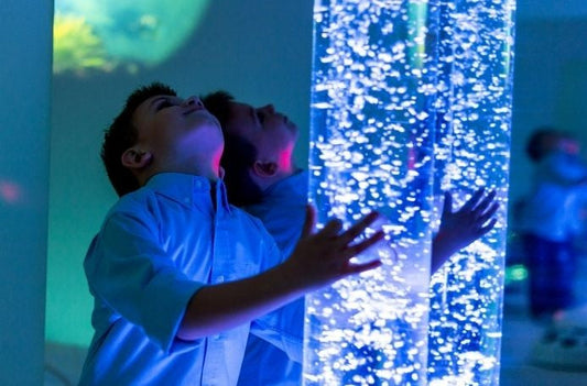 Boy looking at bubble tube