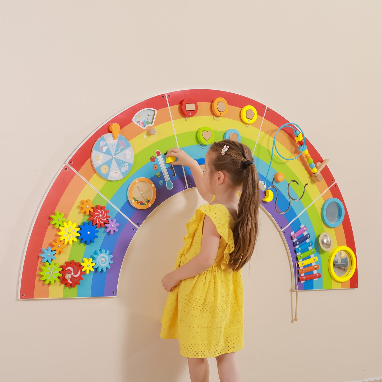 Child playing with Interactive Activity board rainbow