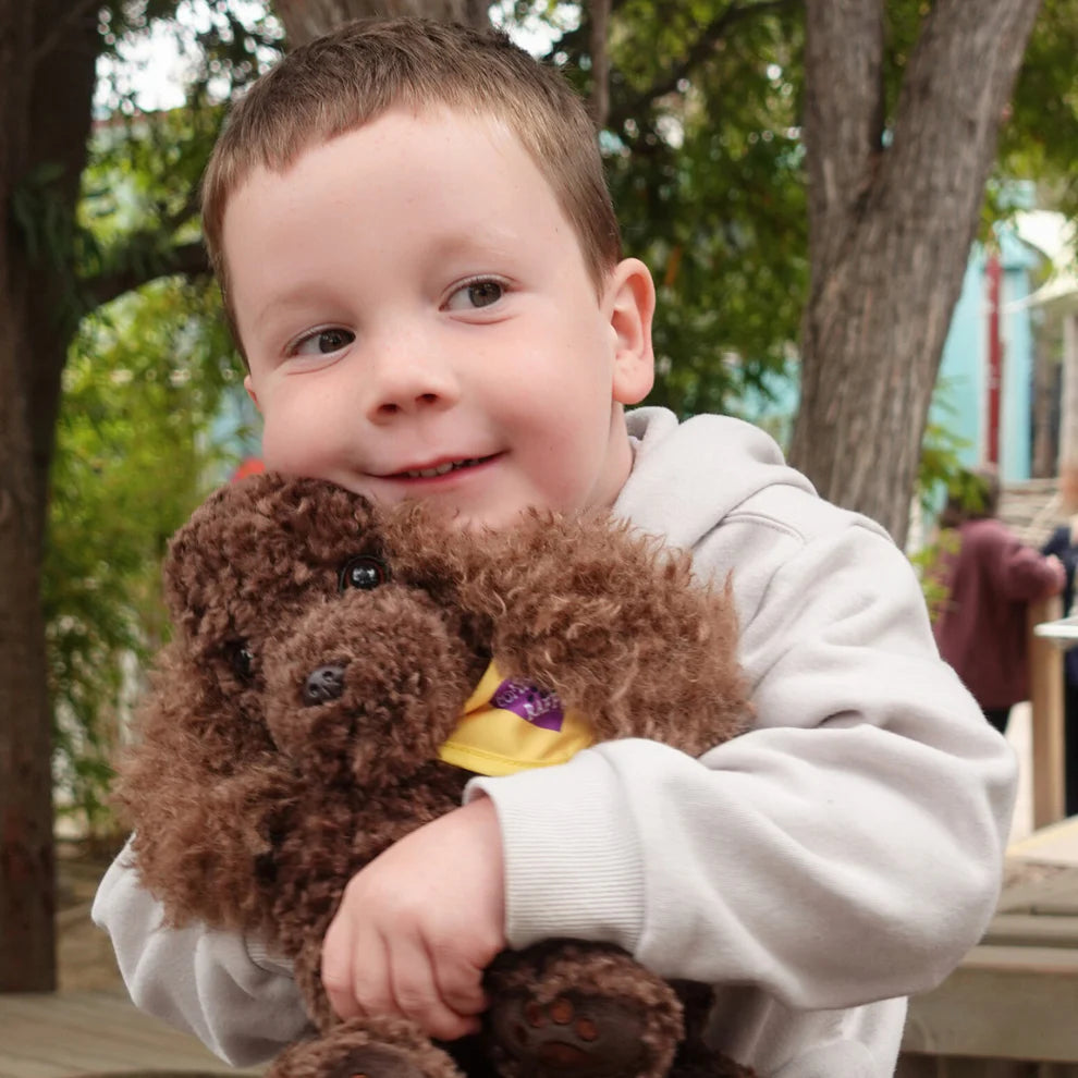 Boy hugging Comfort Me Raffy Plush Dog Anxiety support