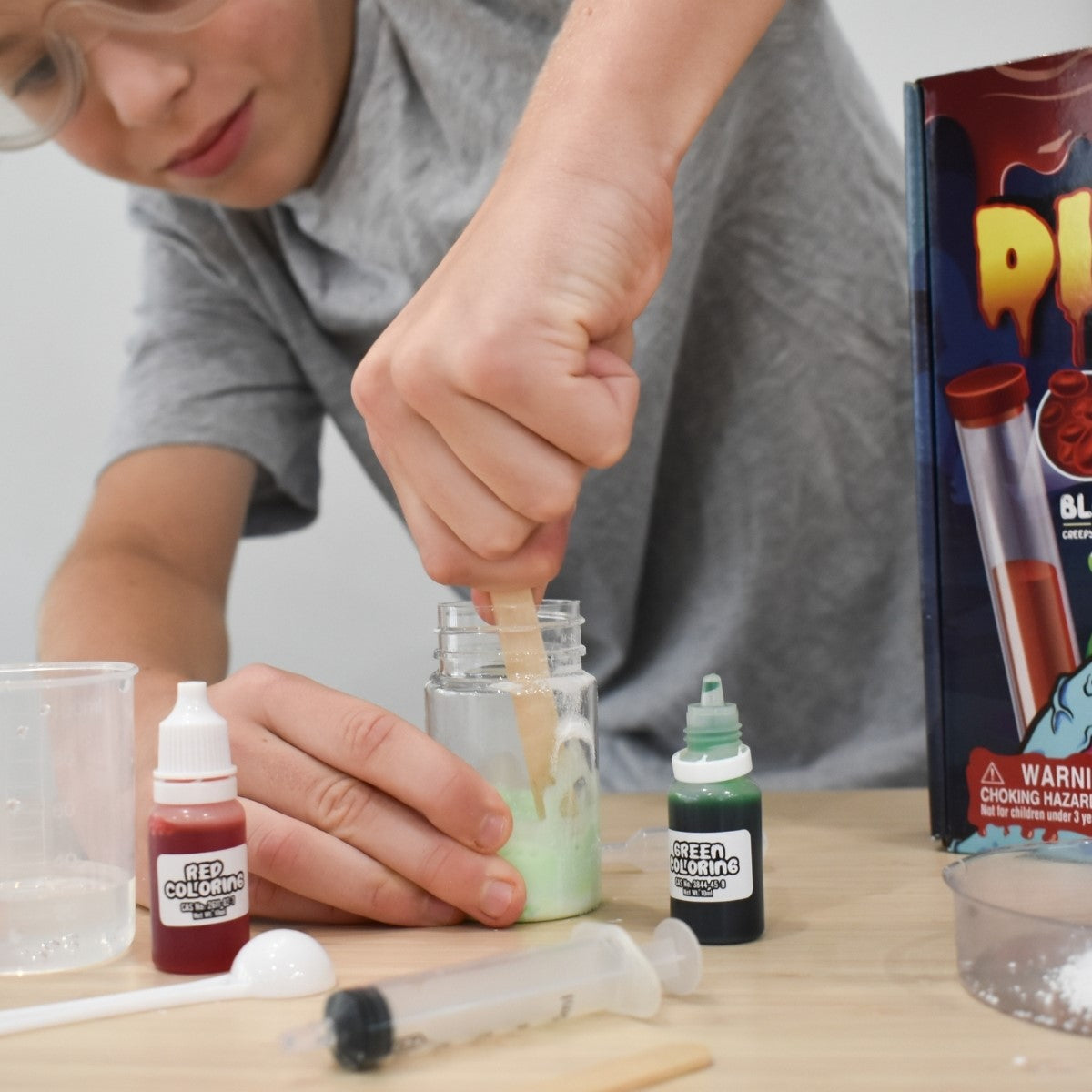 Boy using Disgusting and Gross Science Kit