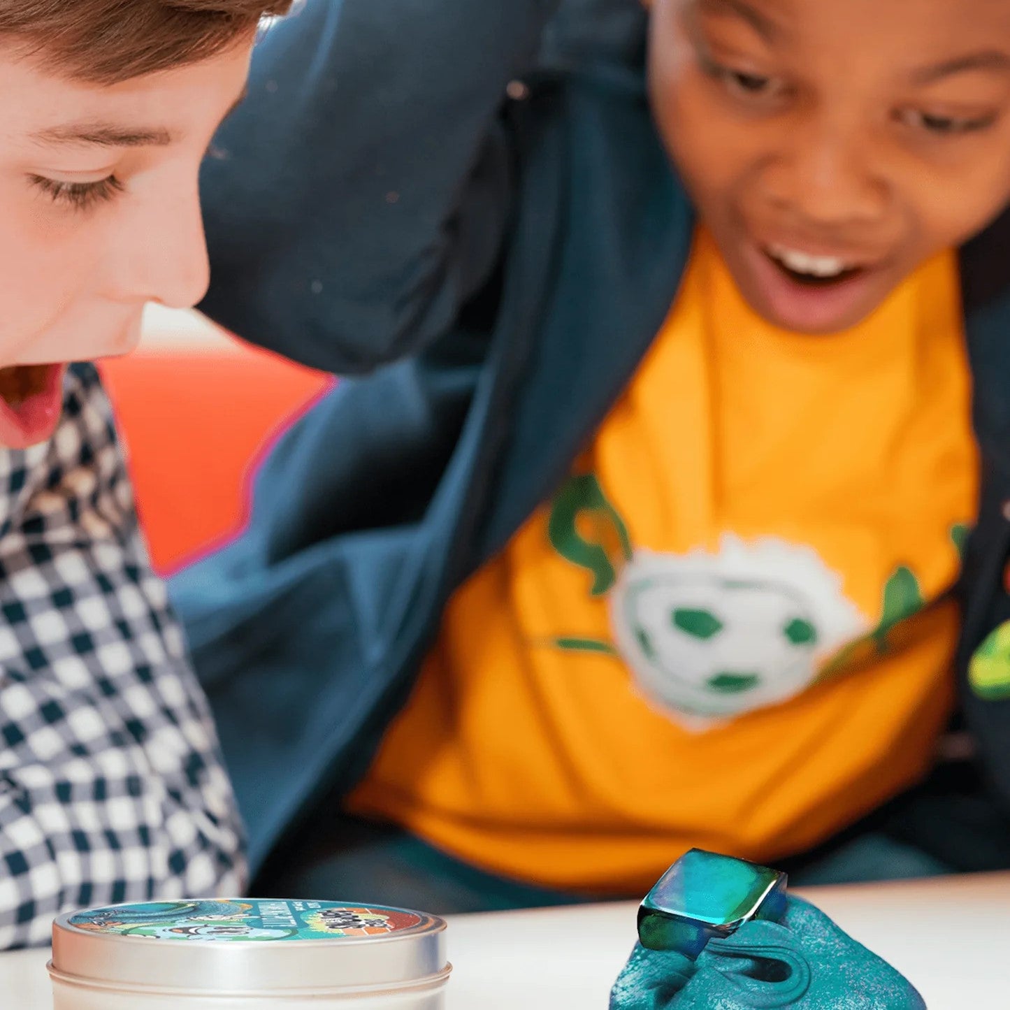 Kids looking at Happy Earth Magnetic Storms Putty