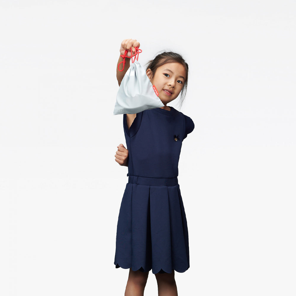 Girl holding bag with Alpine Muffy Ear Muffs