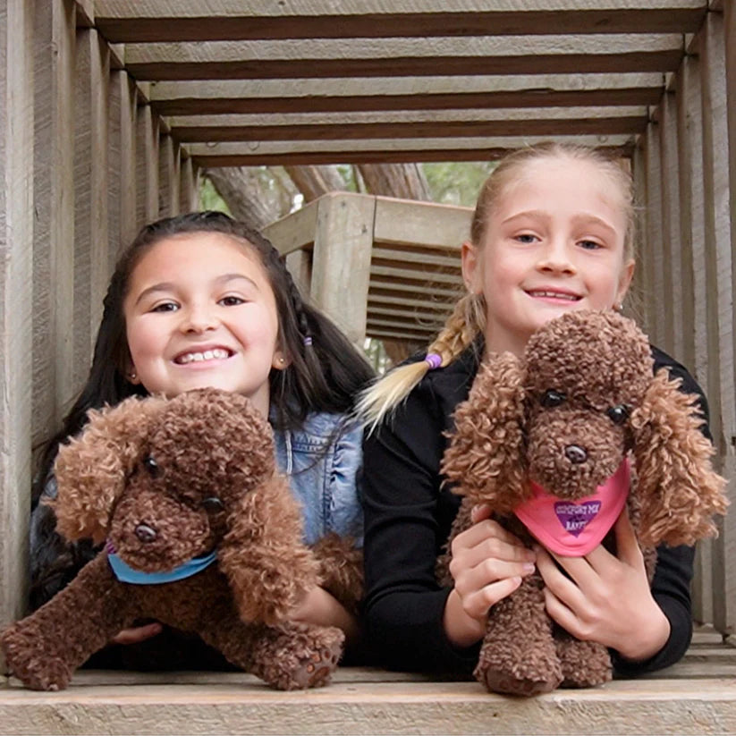 Girls holding Comfort Me Raffy Plush Dog Anxiety support