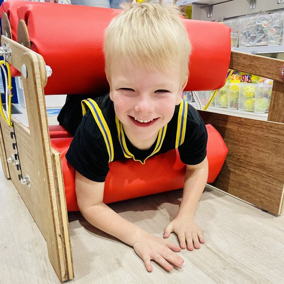 Boy going through sensory pressure roller close up