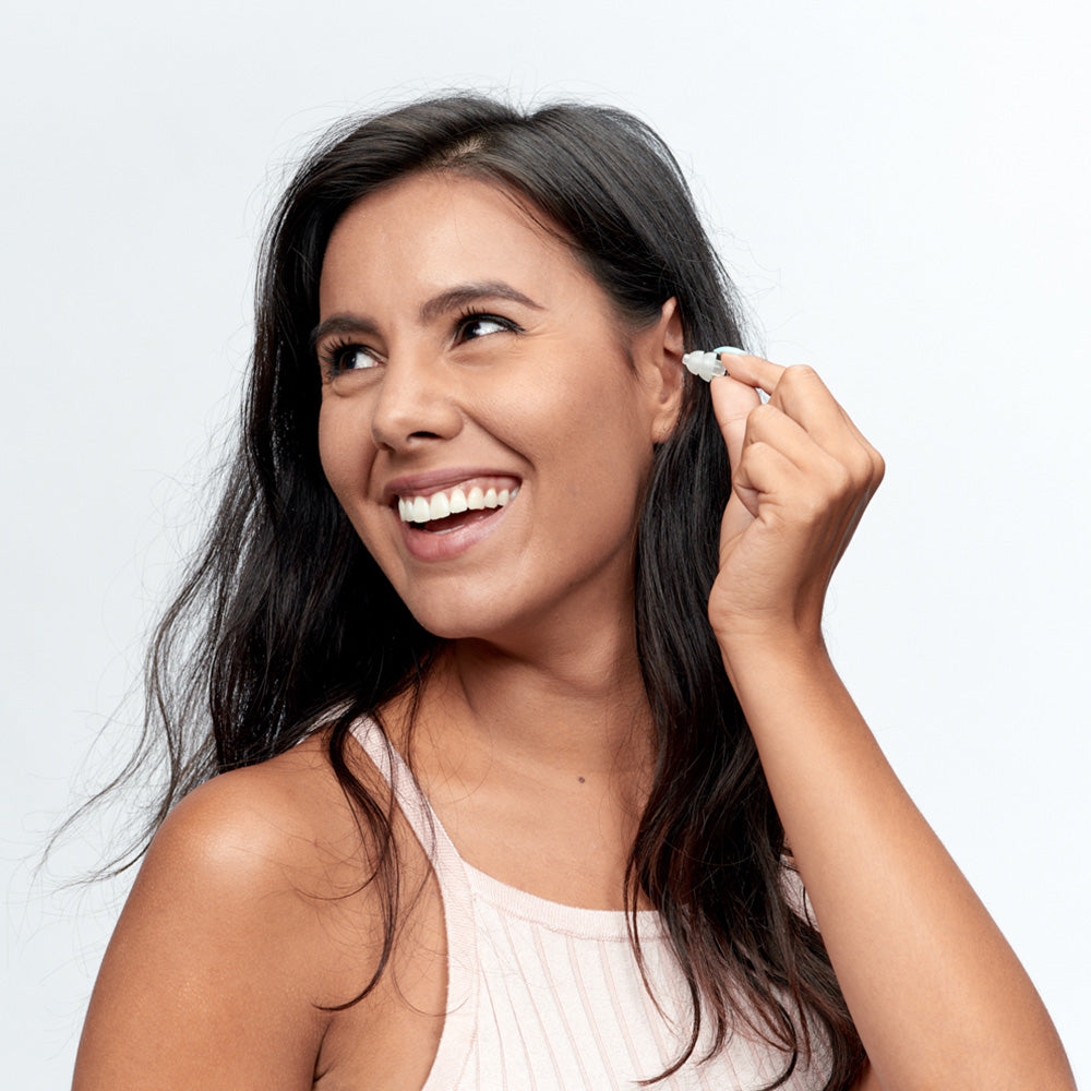 Woman putting in Alpine Party Plug