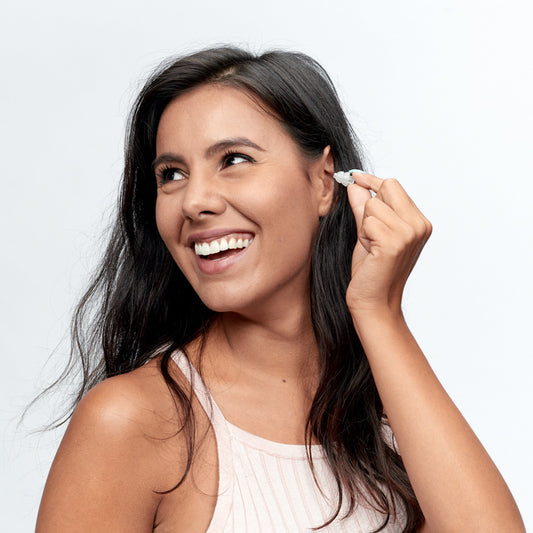 Woman putting in Alpine Party Plug