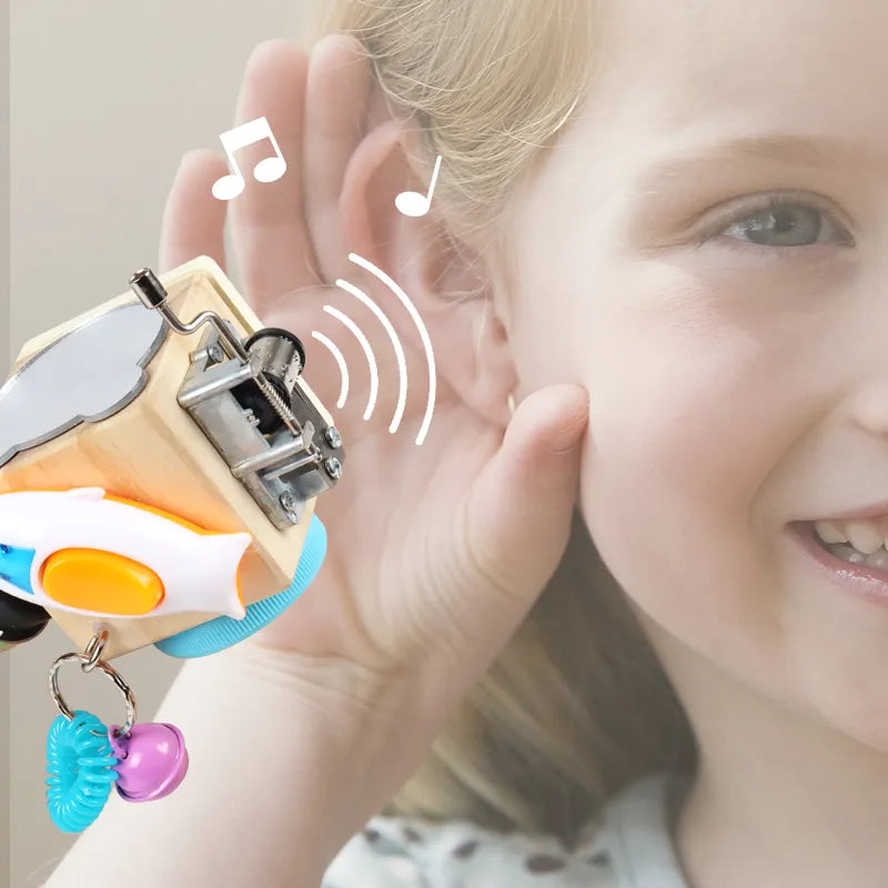 Girl listening to Wooden Montessori Music Busy Block