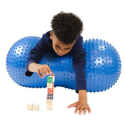 Boy on inflatable massage ball with tactile nubs