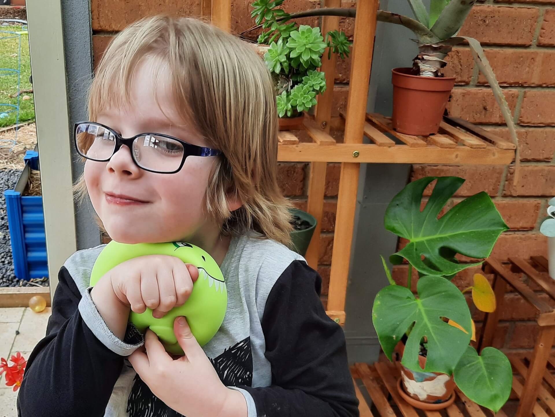 boy with smoosho dinosaur