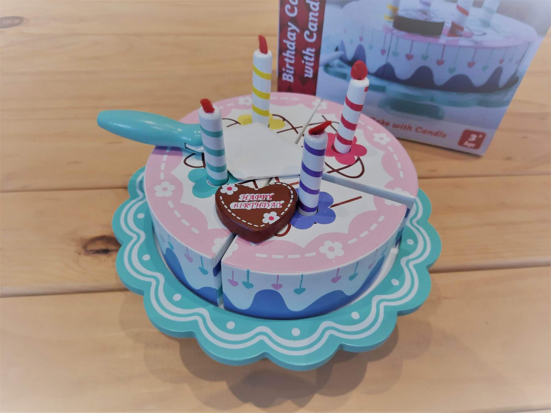 Wooden birthday cake on stand