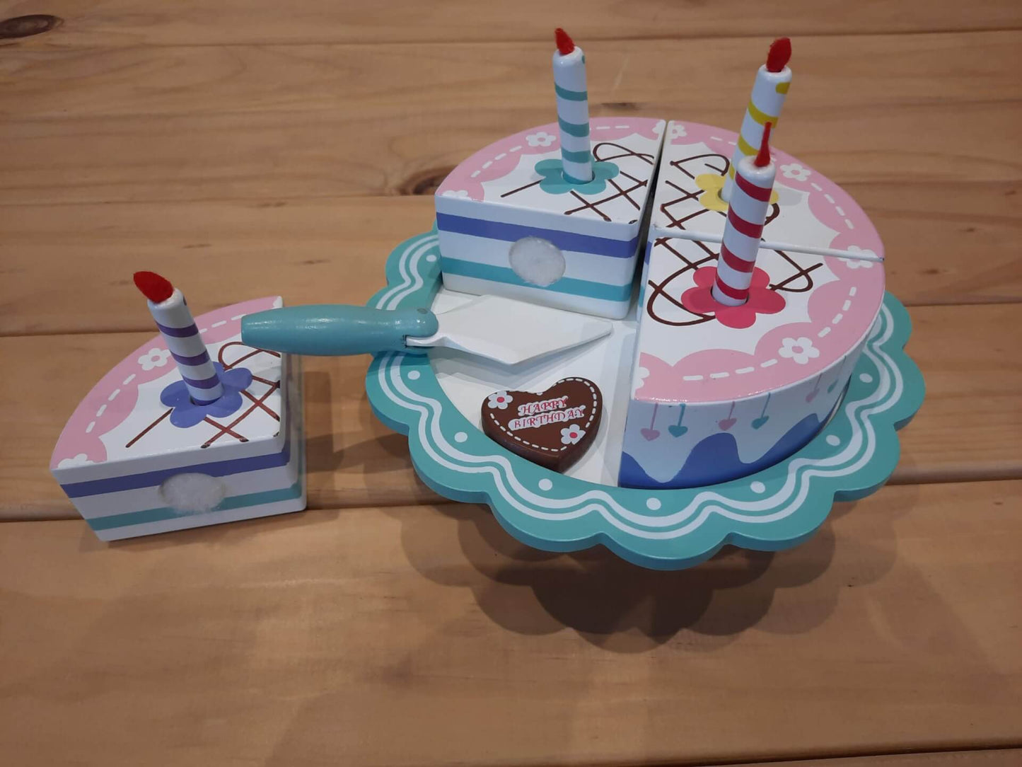 Wooden birthday cake on stand cut