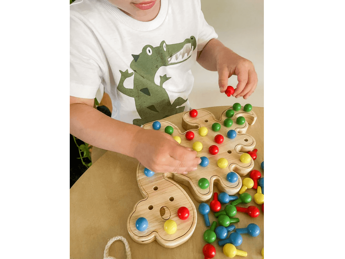 Boy with Dave dinosaur pegboard