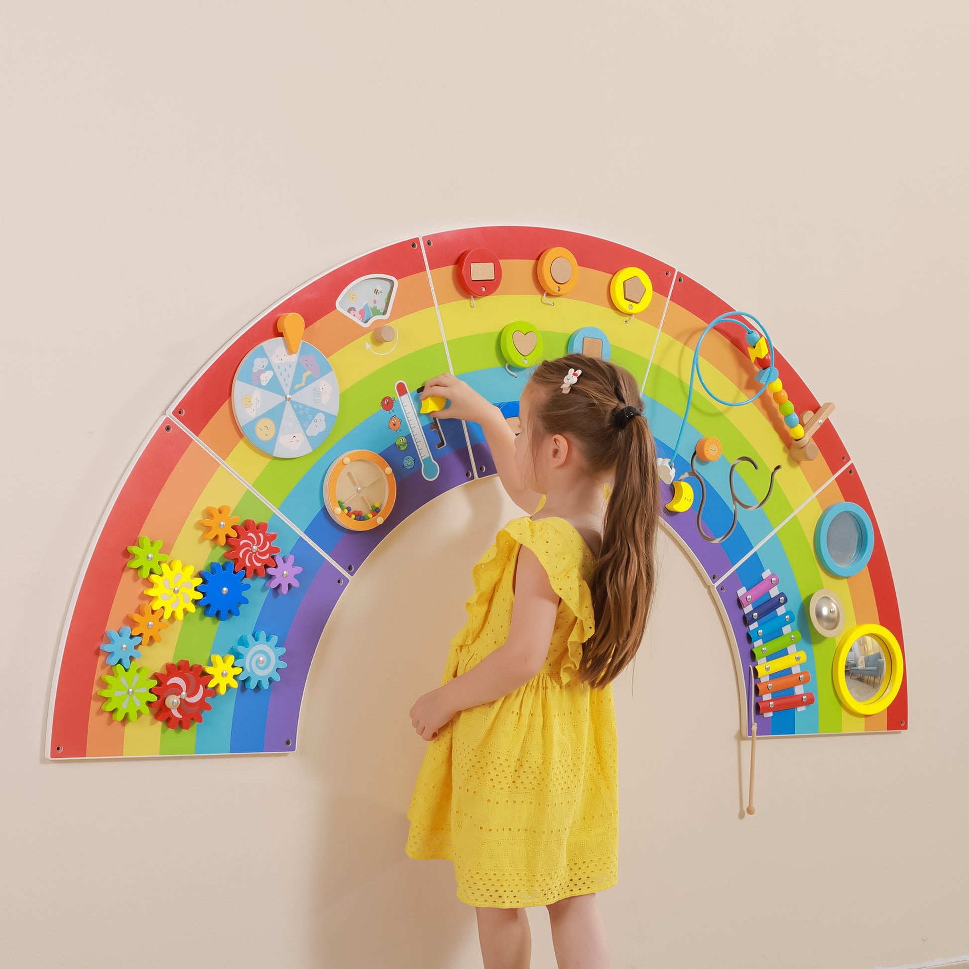 Child playing with Interactive Activity board rainbow
