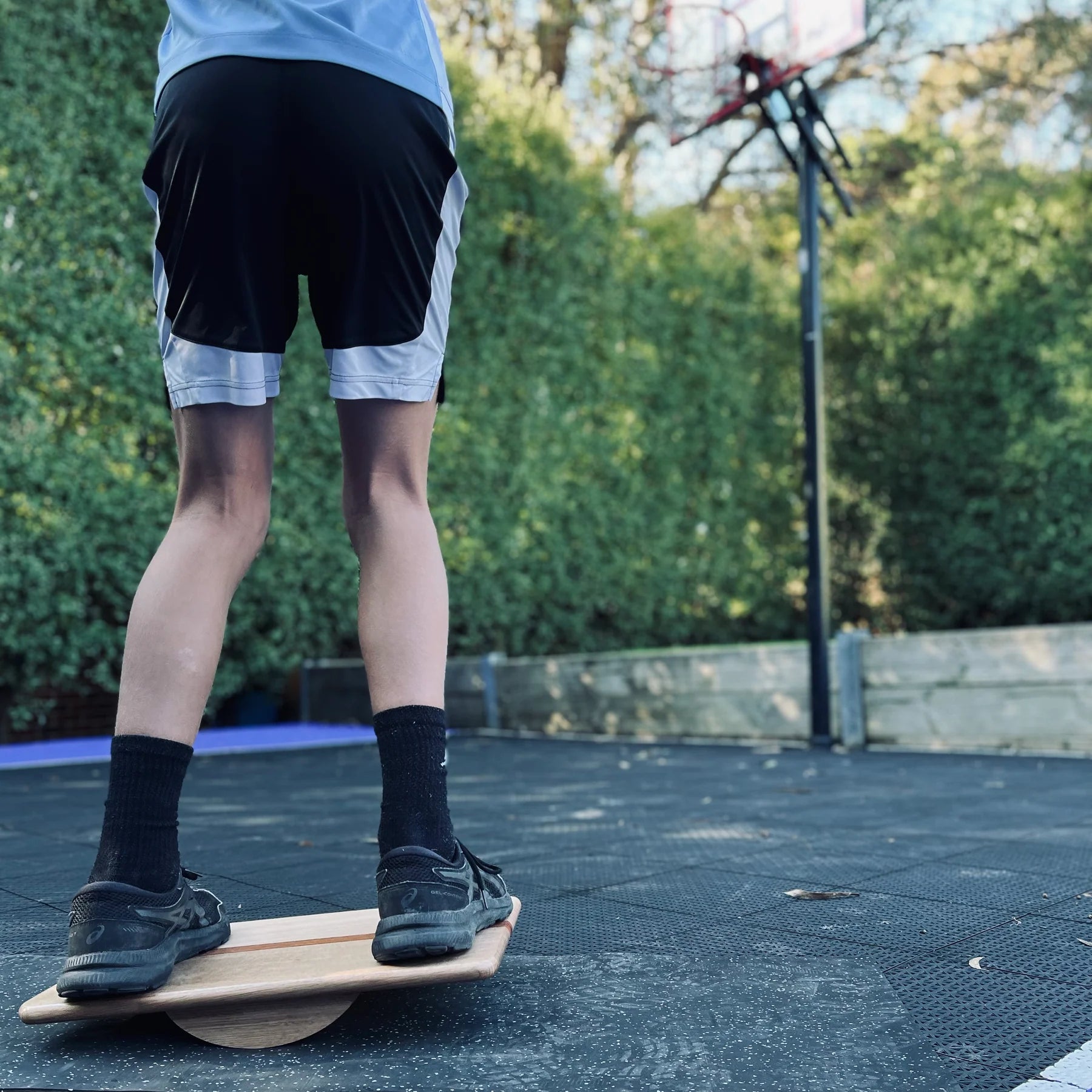Boy balancing on Regular wobble board