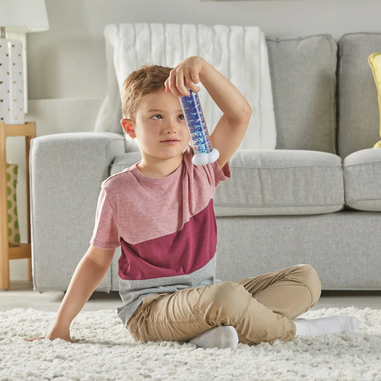 Boy using Sounds of Rain Sensory Tubes