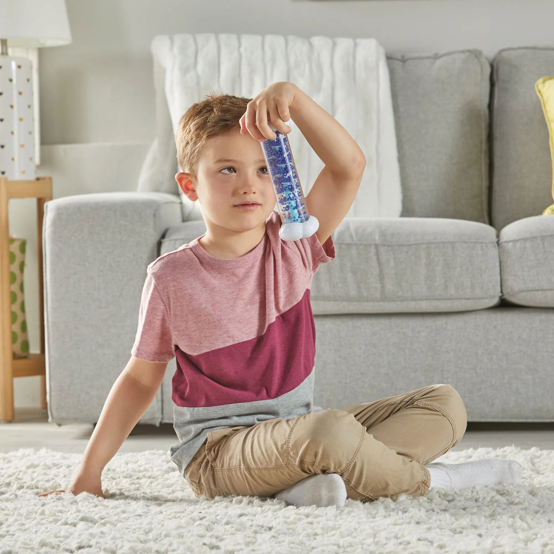 Boy using Sounds of Rain Sensory Tubes