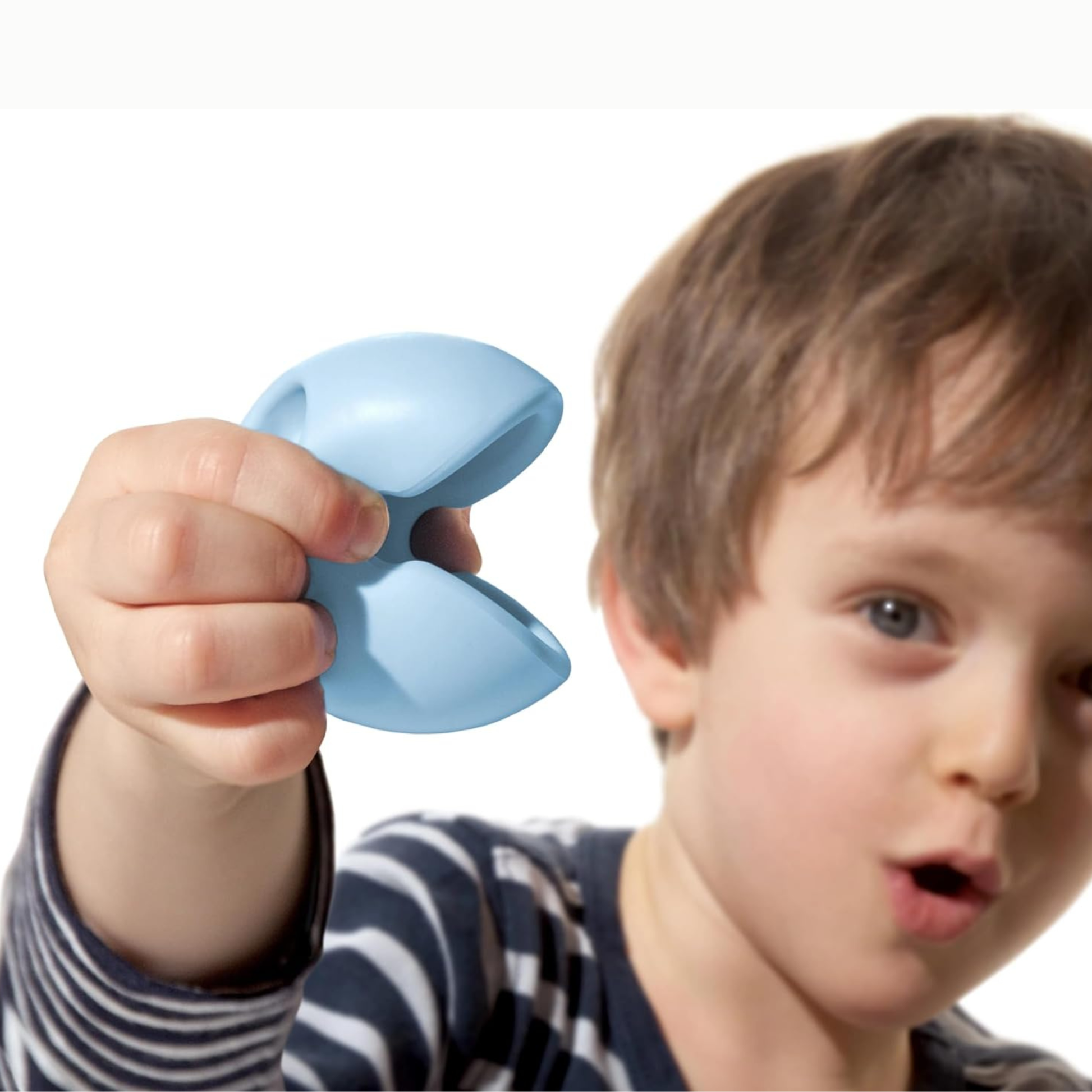 Boy playing with Moluk Mox 3 set Pastel Silicon Balls