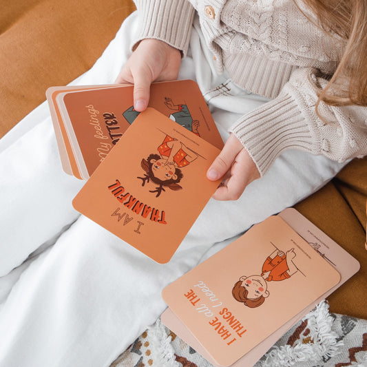 Girl looking at Creative Sprout Affirmation Cards