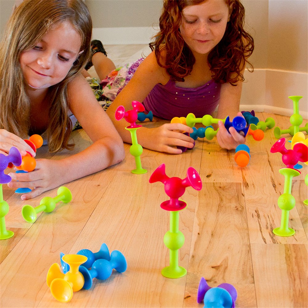 Children playing with Squigz by Fat Brain Toys