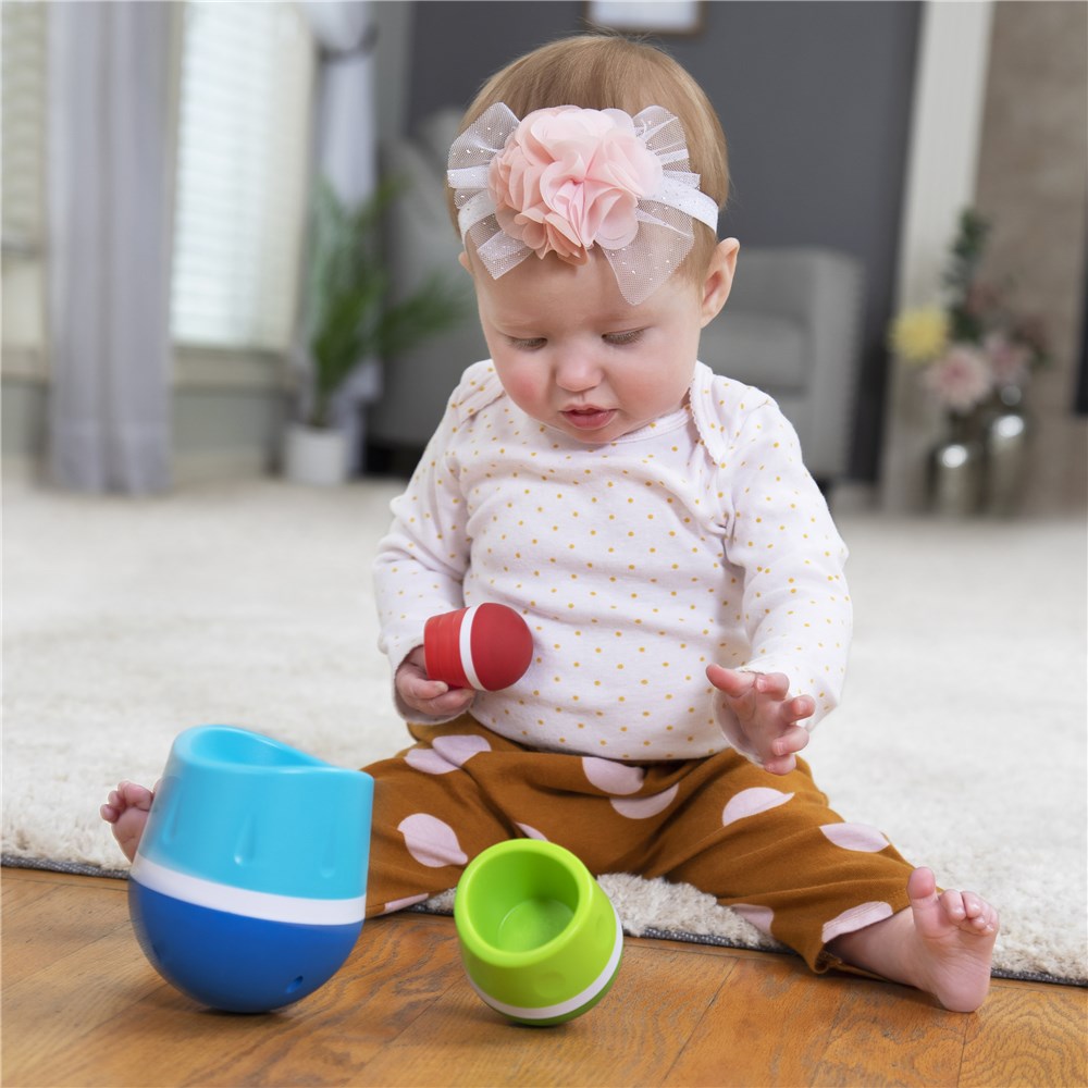 Baby playing with Fat Brain Toys Tumbleroos stacking and nesting toy