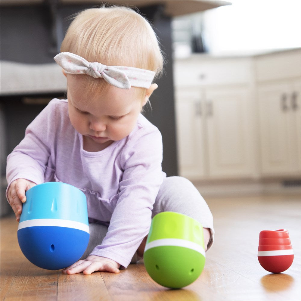 Baby playing with Fat Brain Toys Tumbleroos stacking and nesting toy