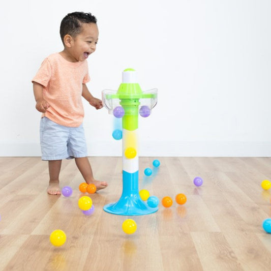 Boy laughing at Fat Brain Spill Again Ball Tower