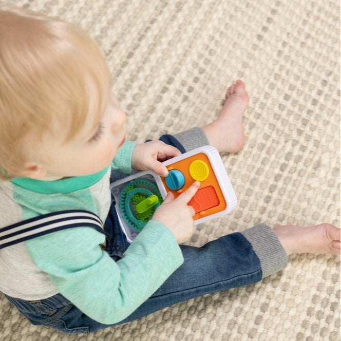 Child playing on the floor with Playtab Go by Fat Brain Toys