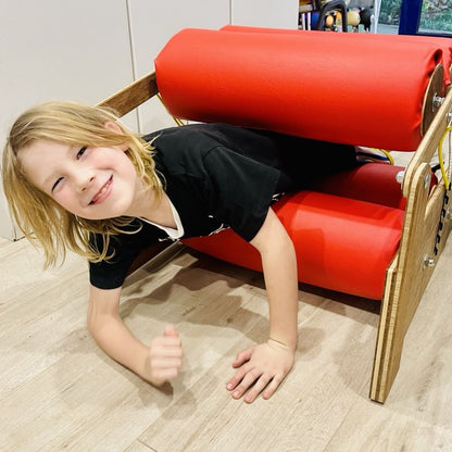 Boy going through sensory pressure roller