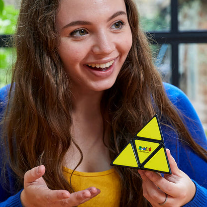Girl solved the Rubiks Pyramid puzzle