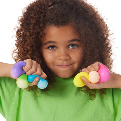 Girl Squishing Nee Doh Teenie Rainbow