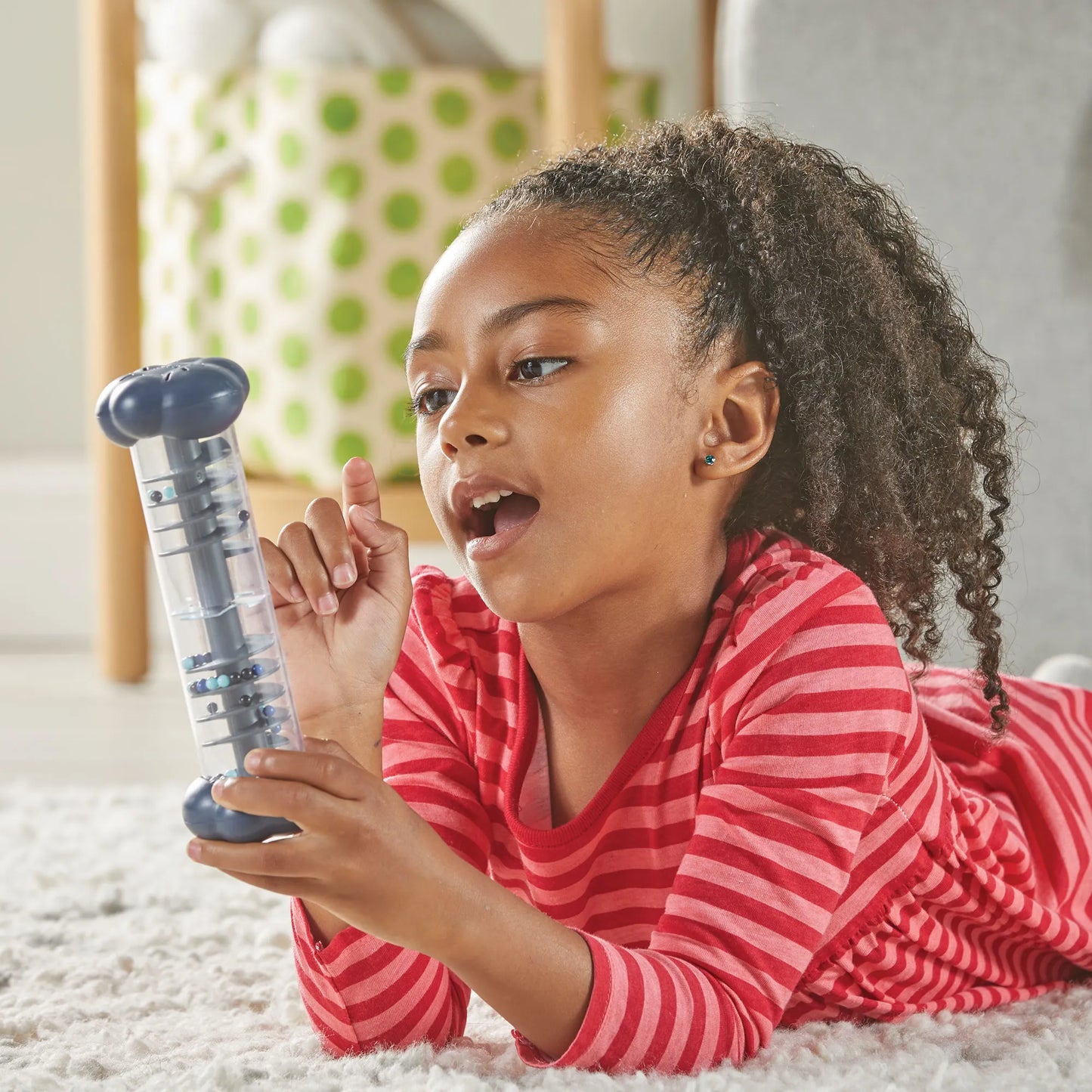 Girl using Sounds of Rain Sensory Tubes