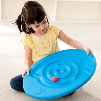 Girl sitting and holding Weplay maze balance board