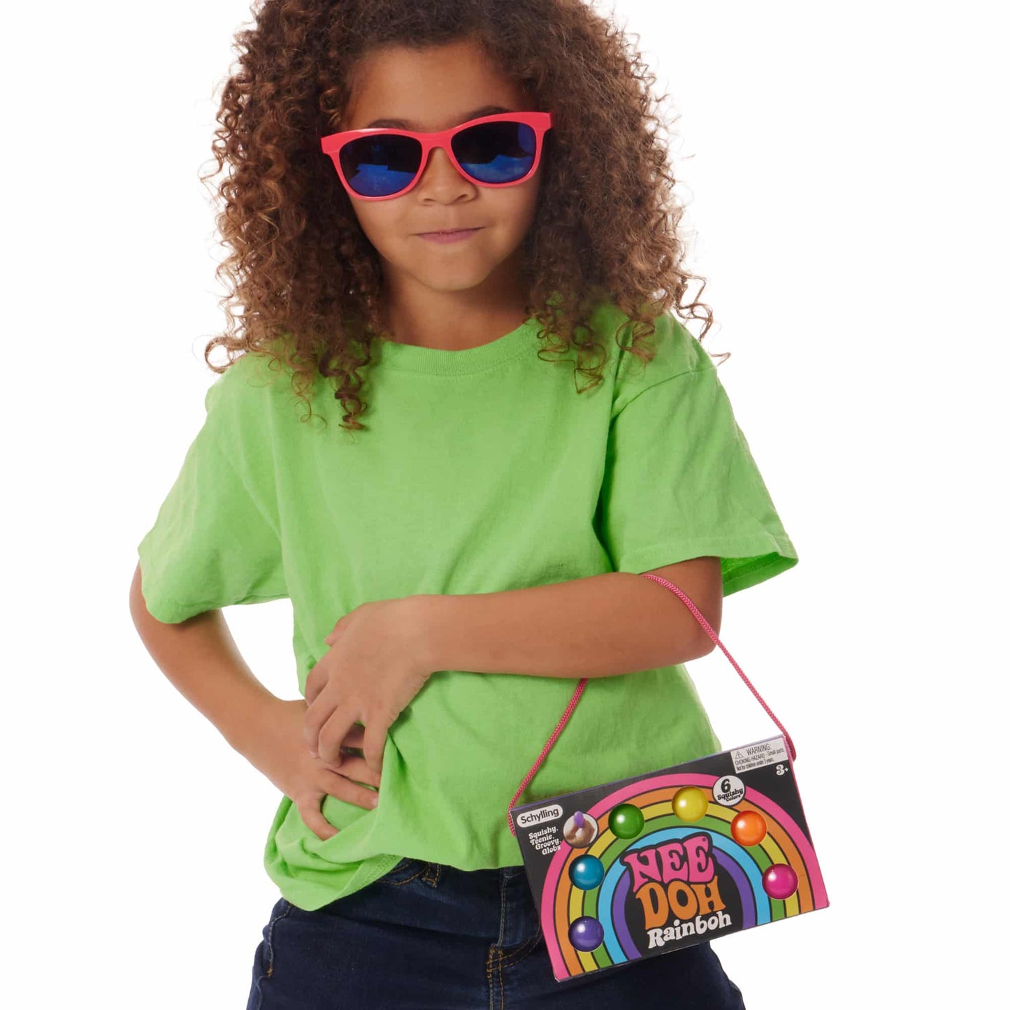 Girl wearing sunglasses and holding Nee Doh Teenie Rainbow