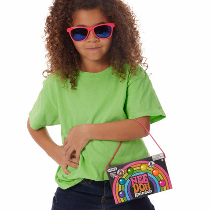 Girl wearing sunglasses and holding Nee Doh Teenie Rainbow