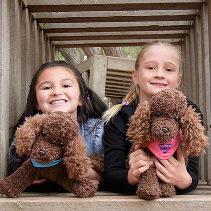 Girls holding Comfort Me Raffy Plush Dog Anxiety support