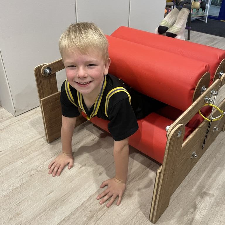 Boy going through sensory pressure roller