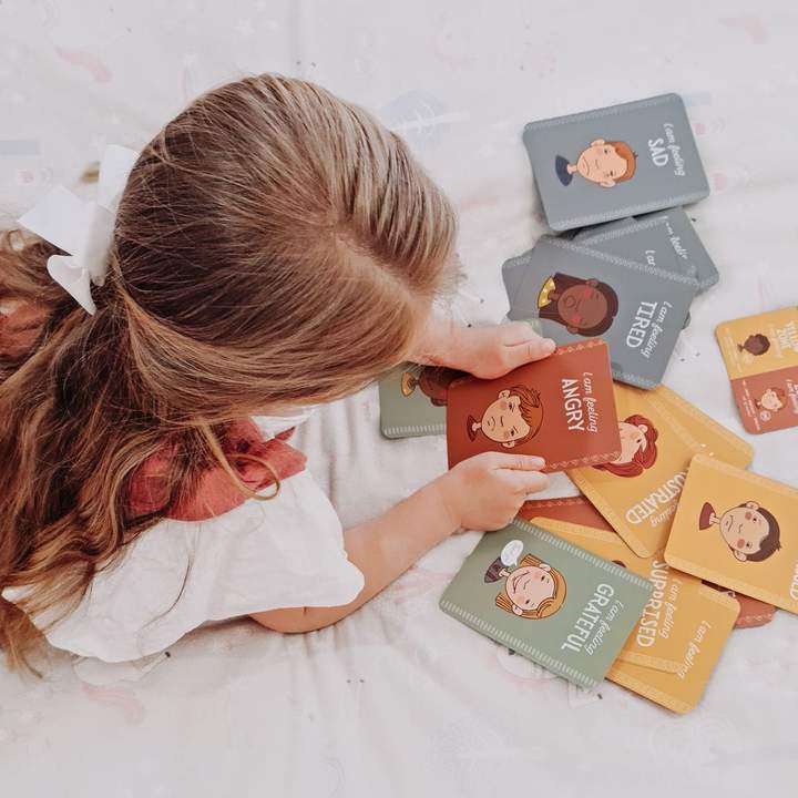 girl looking at Creative Sprout Emotions Cards for kids