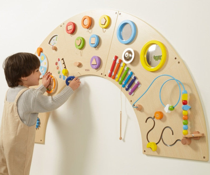 Boy using VIGA Interactive Activity board rainbow natural