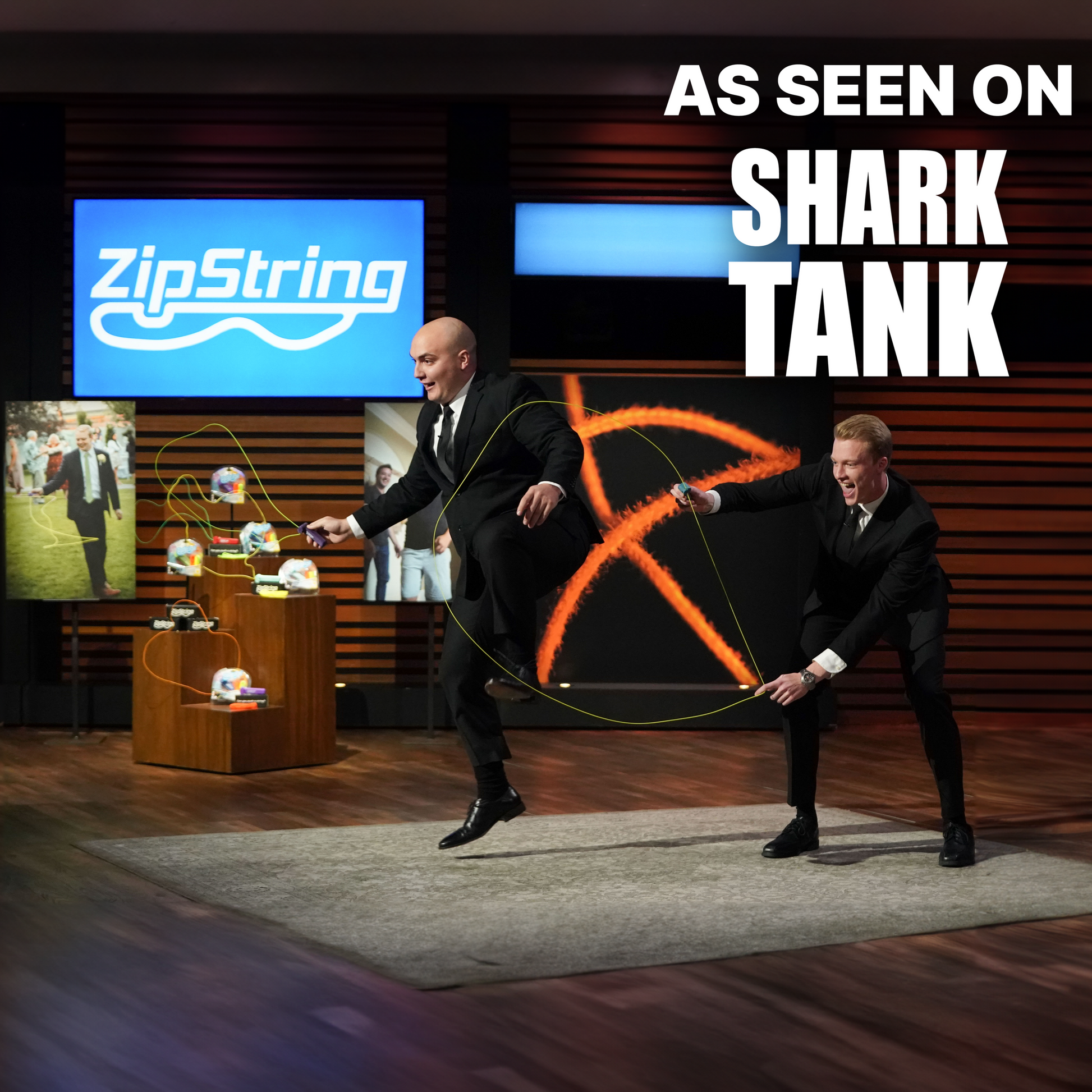 Two men on a stage with a large screen displaying 'ZipString' and text 'As Seen on Shark Tank'.