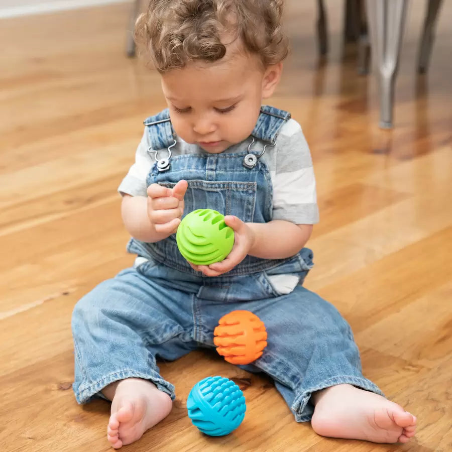 Toddler holding Sensory Rollers balls