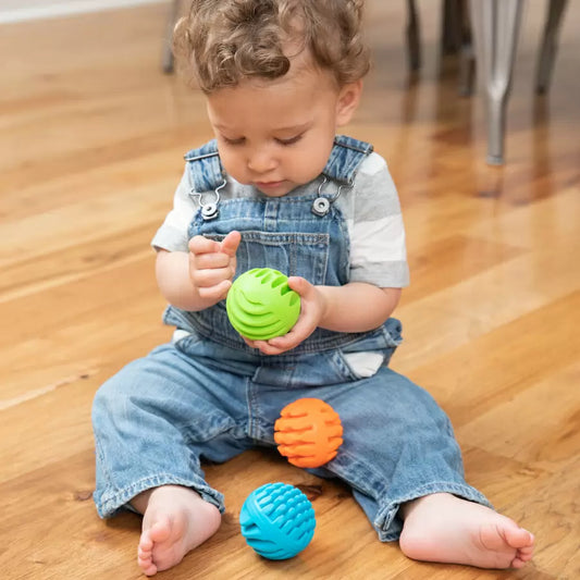 Toddler holding Sensory Rollers balls