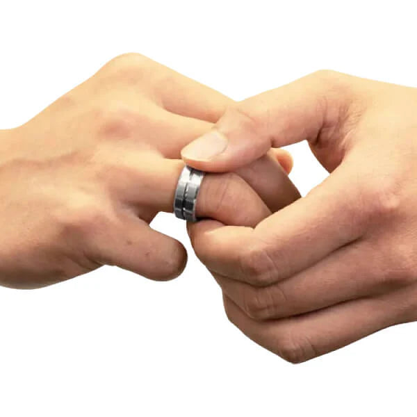 Two hands with a silver ring on a white background rotating fidget ring